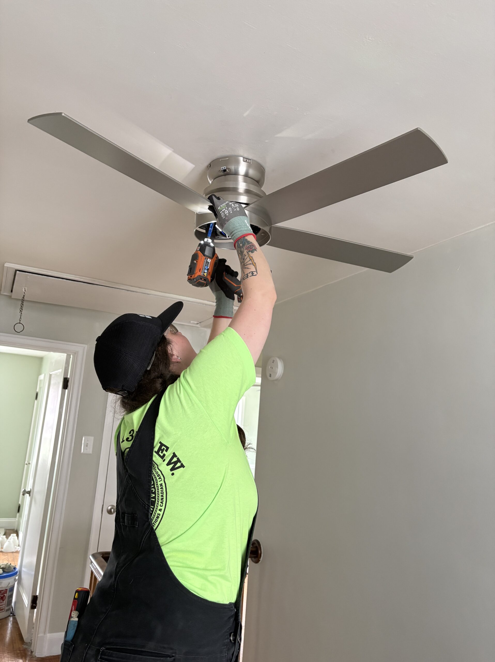 Photo of Rose Electric Co installing a ceiling fan