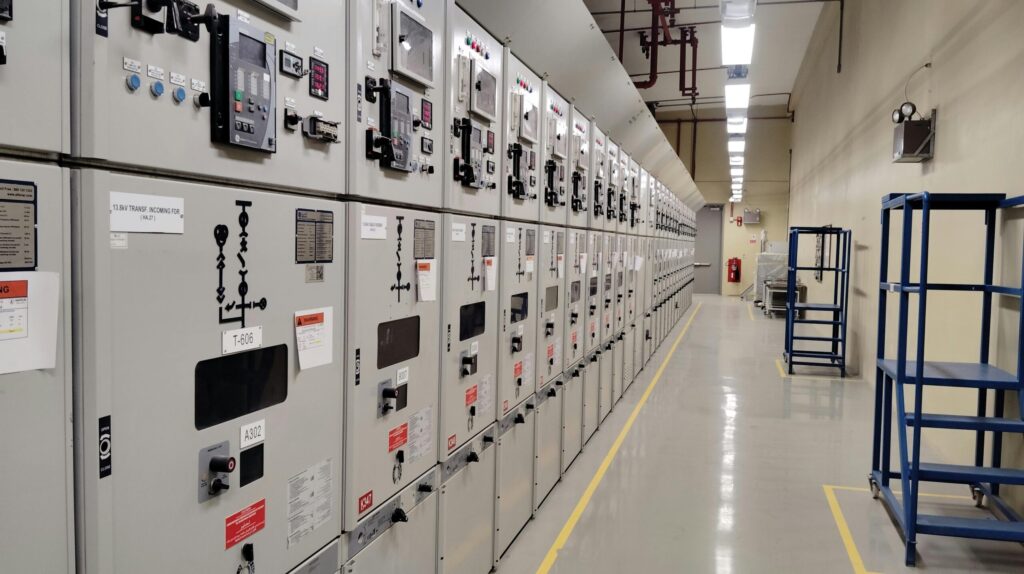 pexels-photo-33706880-33706880 Long row of control panels in an industrial electrical control room, well-lit and spacious.